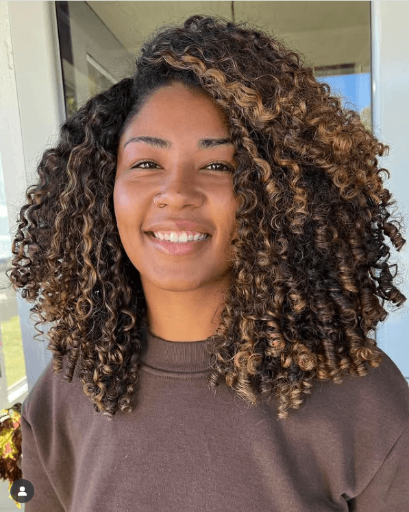 Dimensional Caramel Highlights on Curly Brown Hair